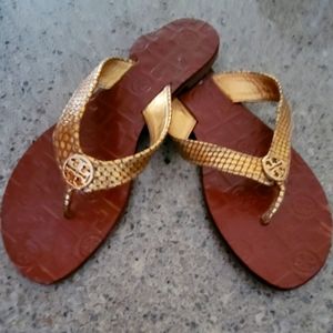 Tory Burch gold leather upper, wth man made lining.